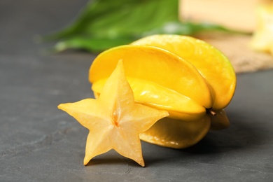Delicious carambola and slice on black table