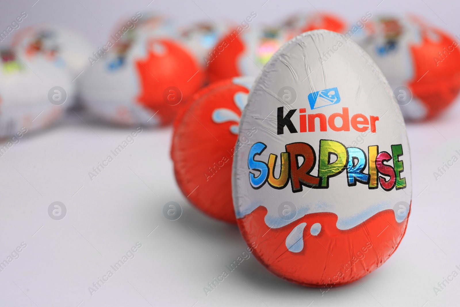 Photo of Sveti Vlas, Bulgaria - June 26, 2023: Kinder Surprise Eggs on white background, closeup. Space for text