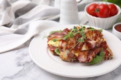 Photo of Tasty sandwich with bacon and microgreens on white marble table