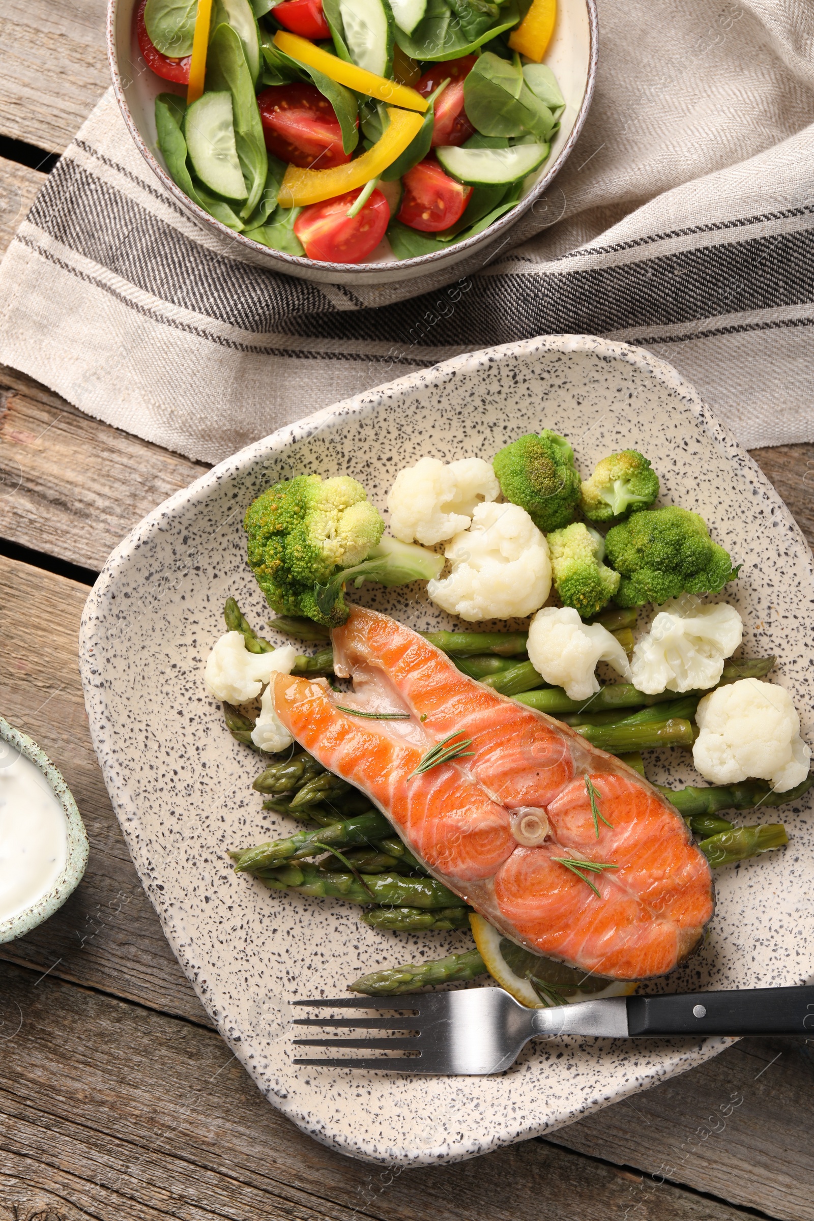 Photo of Healthy meal. Tasty grilled salmon with vegetables served on wooden table, flat lay