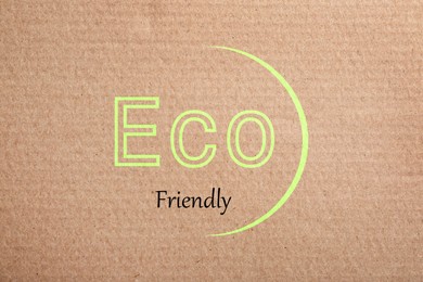 Phrase Eco Friendly written on cardboard, top view