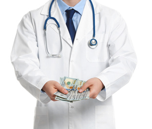Doctor with bribe on white background, closeup. Corruption in medicine