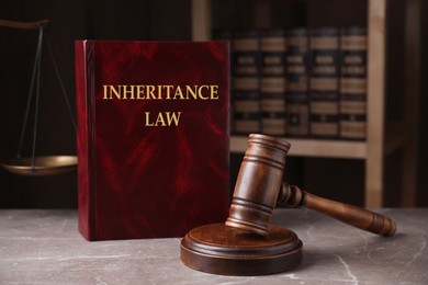 Inheritance law and gavel on grey marble table, closeup