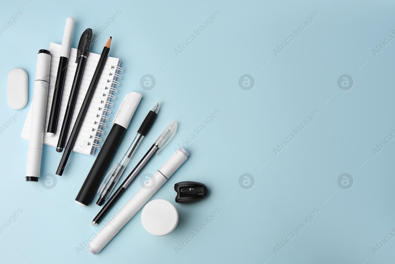 Photo of Flat lay composition with different school stationery on light blue background, space for text. Back to school