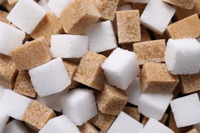 Photo of White and brown sugar cubes as background, top view