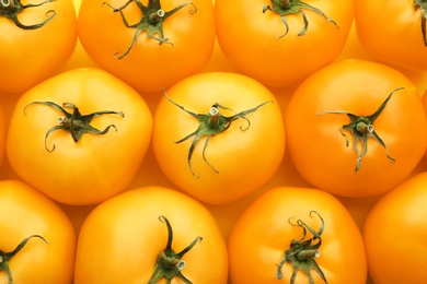Photo of Delicious ripe yellow tomatoes as background, closeup
