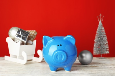 Composition with piggy bank and Christmas decor on table