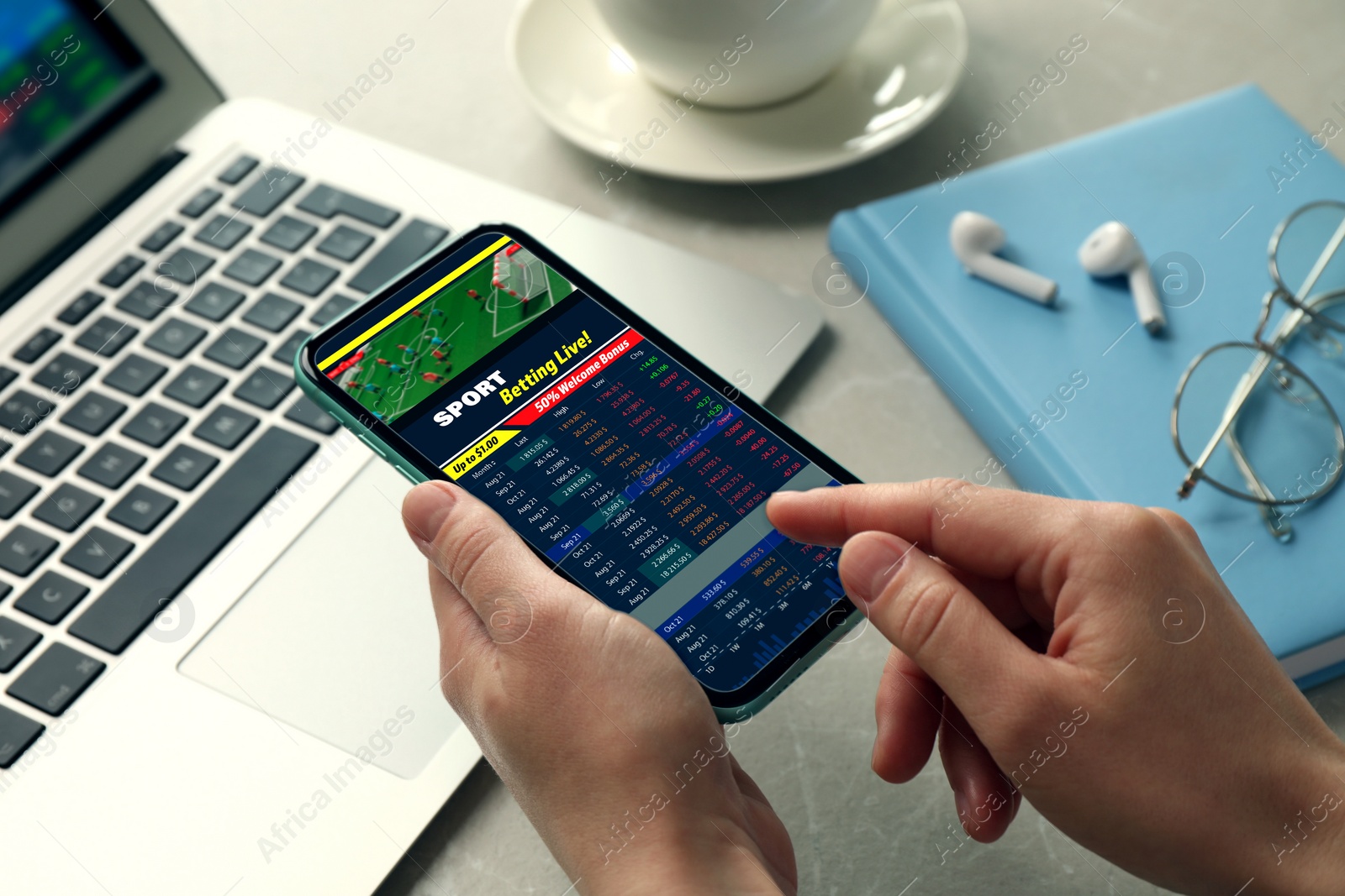 Image of Woman betting on sports using smartphone at table, closeup. Bookmaker website on display