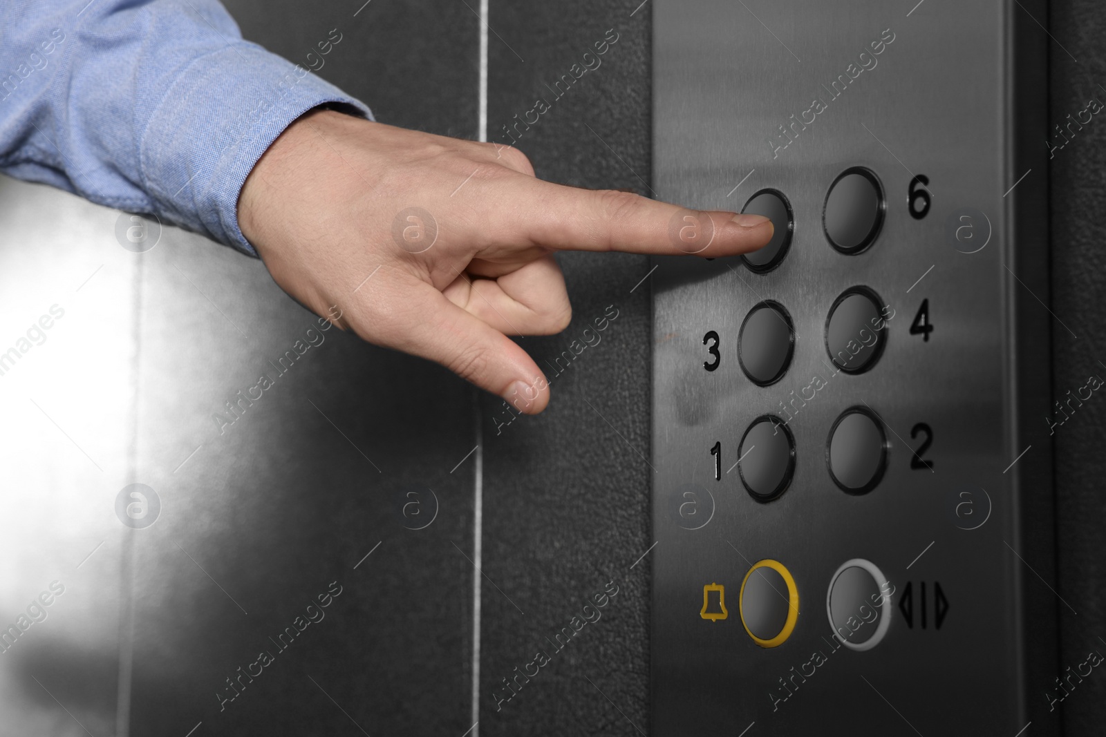 Photo of Man choosing floor in elevator, closeup view