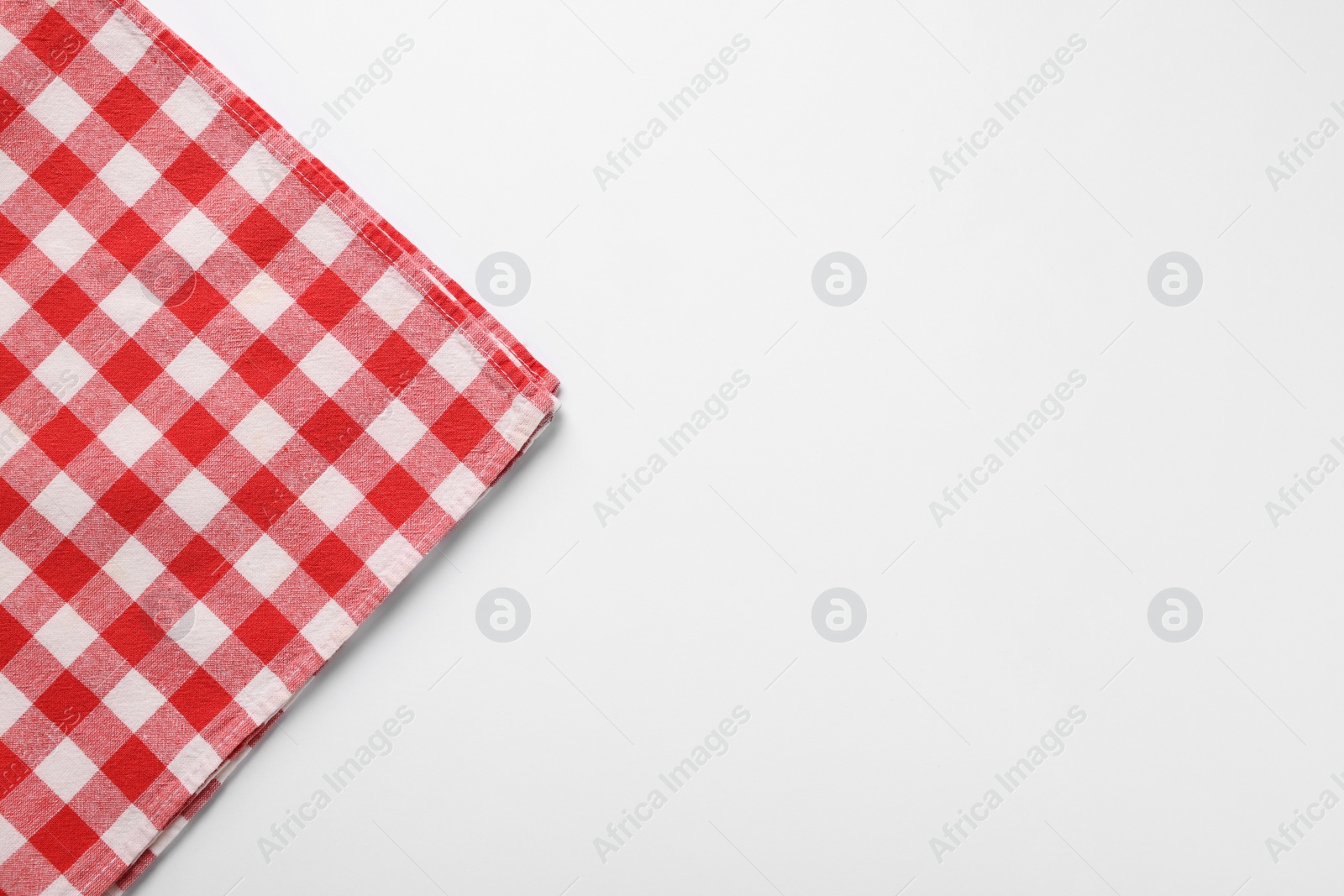 Photo of Red checkered tablecloth on white background, top view