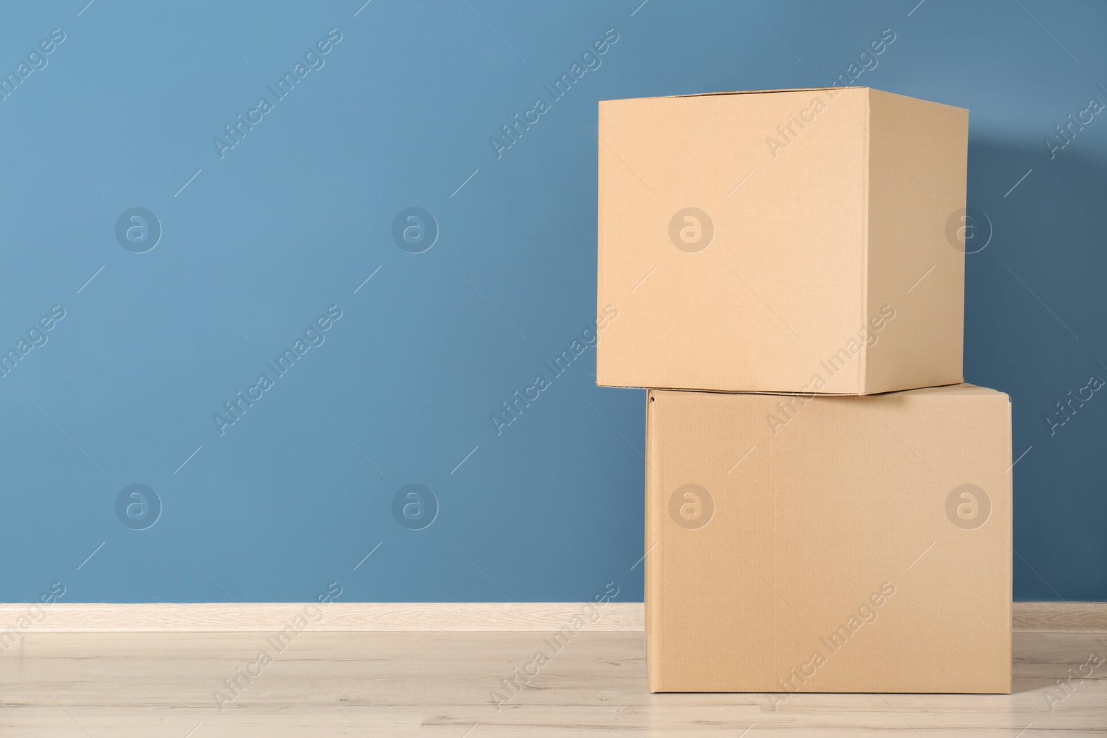 Photo of Cardboard boxes near color wall