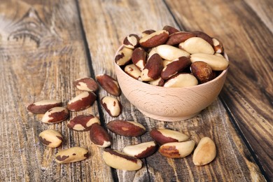 Many delicious Brazil nuts on wooden table