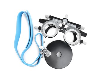 Trial frame and head mirror on white background, top view. Ophthalmologist tools