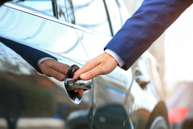 Closeup view of man opening car door