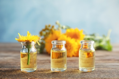 Composition with essential oil and flowers on table