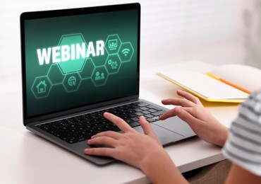 Image of Webinar. Woman using laptop at table, closeup