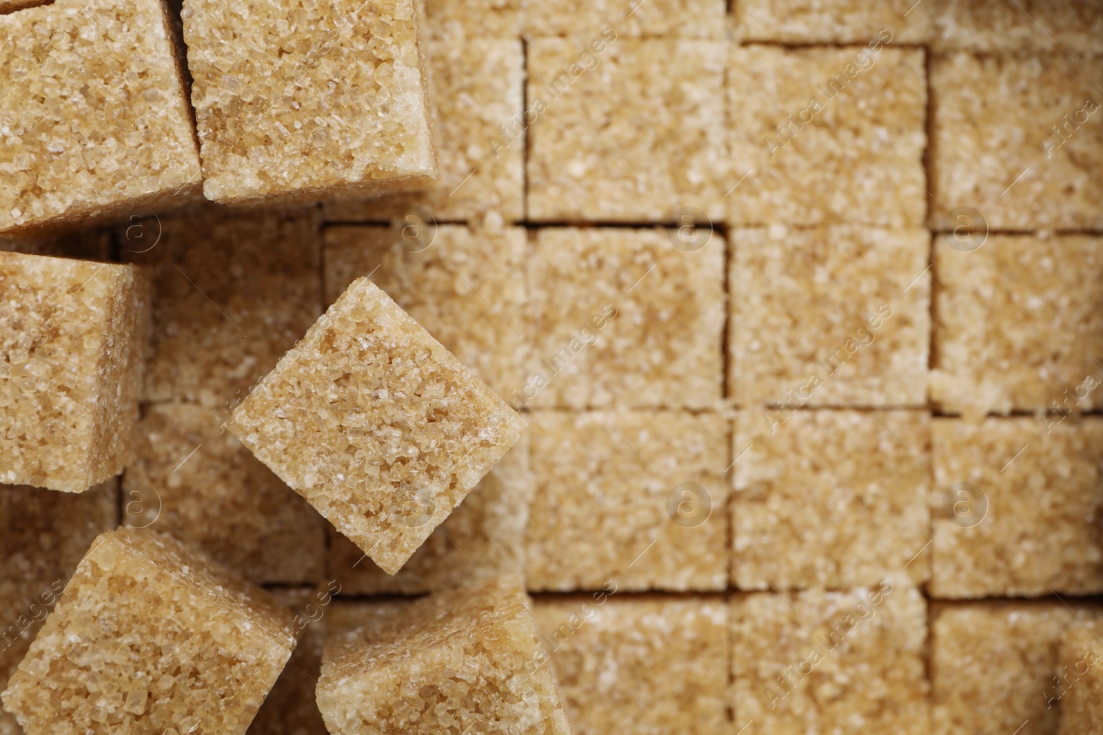 Photo of Brown sugar cubes as background, closeup view