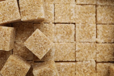 Photo of Brown sugar cubes as background, closeup view