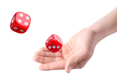 Man throwing red dice on white background, closeup