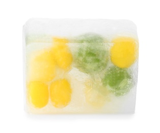 Photo of Corn grains and green peas in ice cube on white background. Frozen vegetables