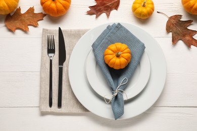 Stylish autumn table setting on white wooden background, flat lay