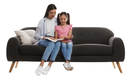 Photo of Young woman and her daughter reading book on comfortable grey sofa against white background