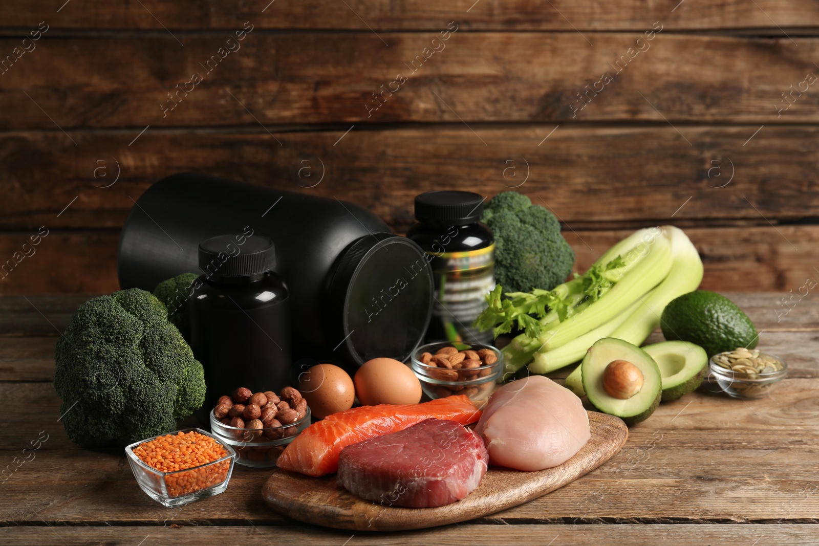 Photo of Set of products rich in amino acids and supplements on wooden table