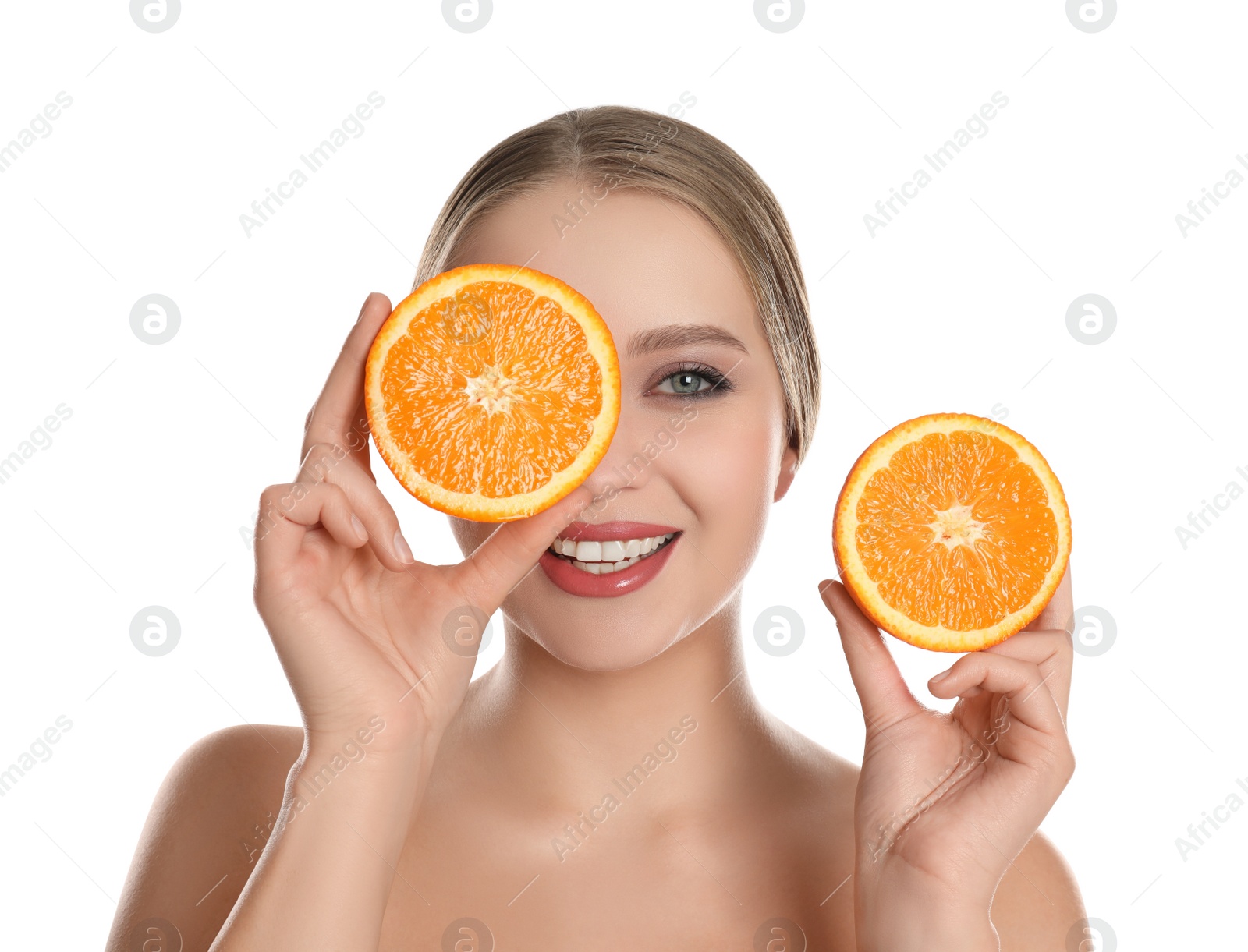 Photo of Young woman with cut orange on white background. Vitamin rich food