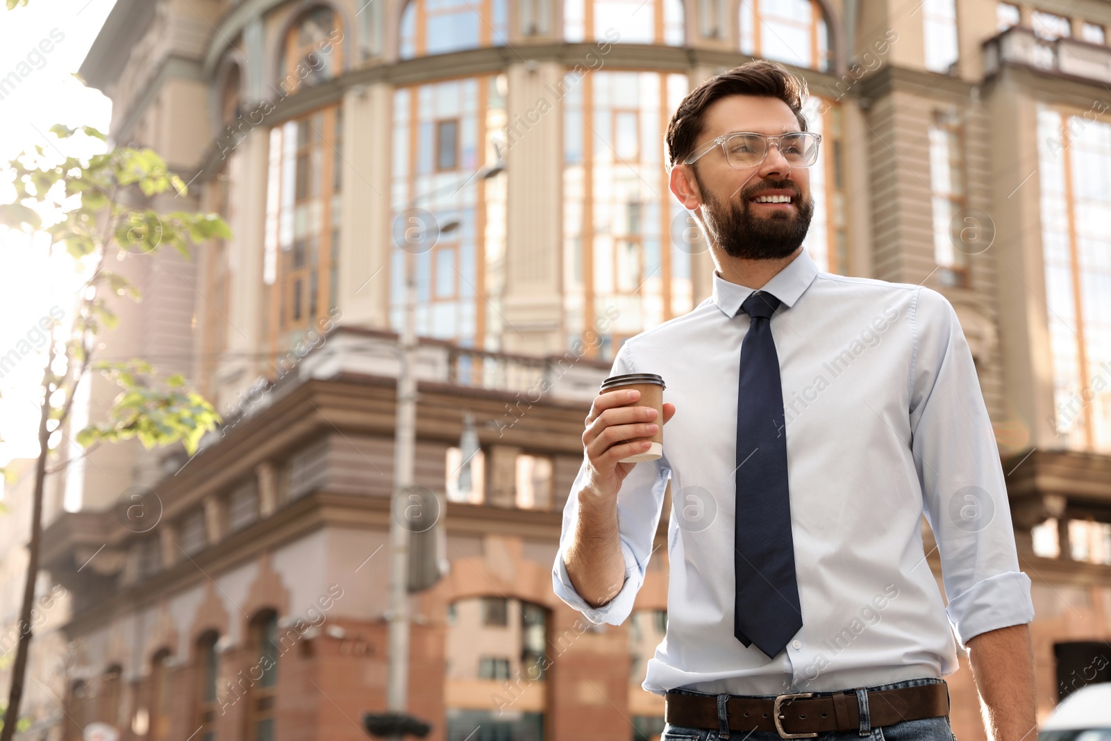 Photo of Handsome businessman in stylish outfit on city street