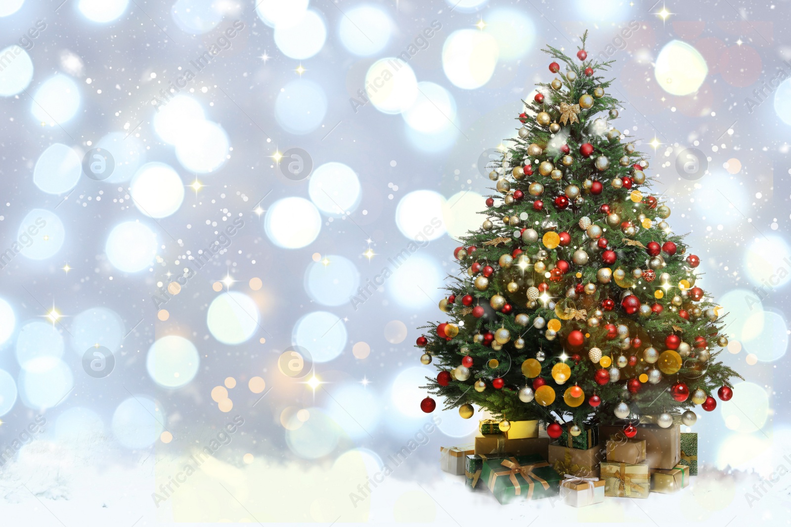 Image of Beautifully decorated Christmas tree and gift boxes on blurred background, space for text. Bokeh effect