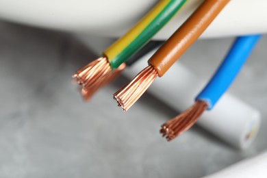 Colorful electrical wires on blurred background, closeup