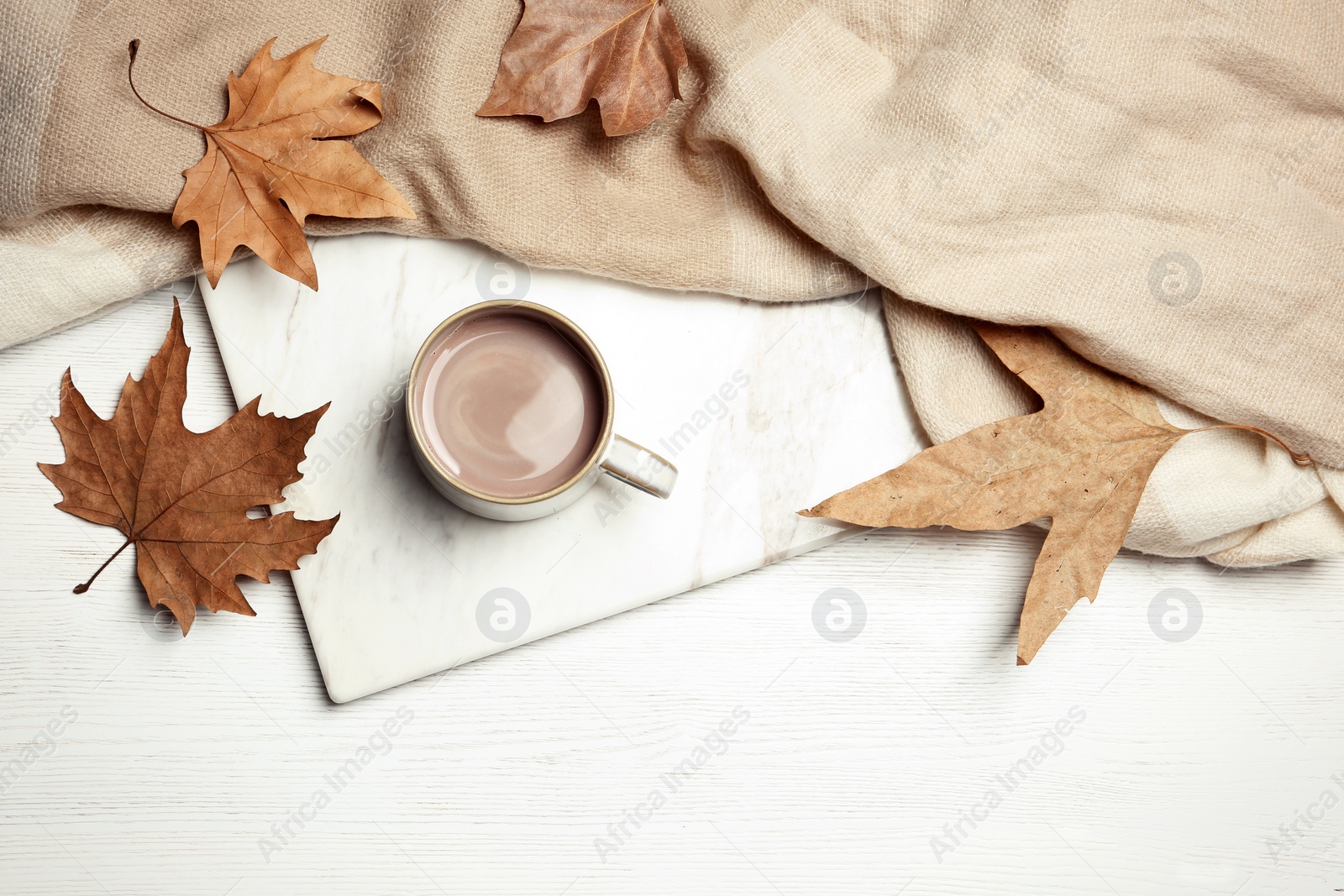 Photo of Flat lay composition with hot cozy drink and autumn leaves on wooden background