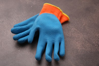 Pair of color gardening gloves on brown textured table