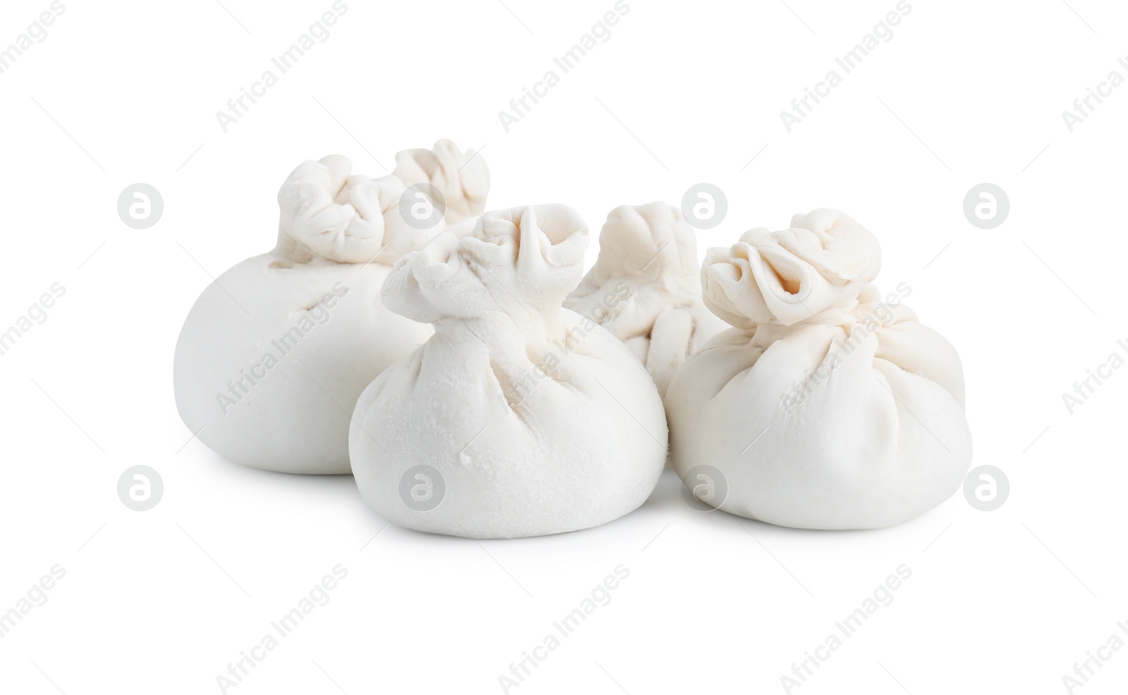 Photo of Uncooked khinkali (dumplings) isolated on white. Georgian cuisine