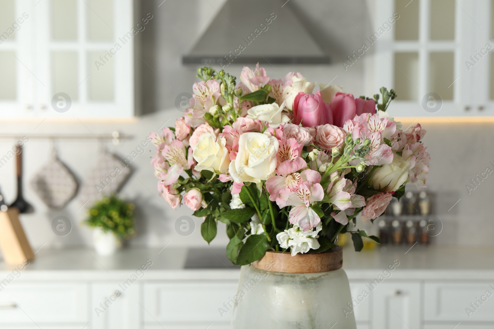 Photo of Beautiful bouquet of fresh flowers in vase indoors