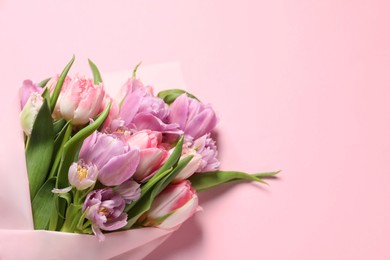 Photo of Beautiful bouquet of colorful tulip flowers on pink background, top view
