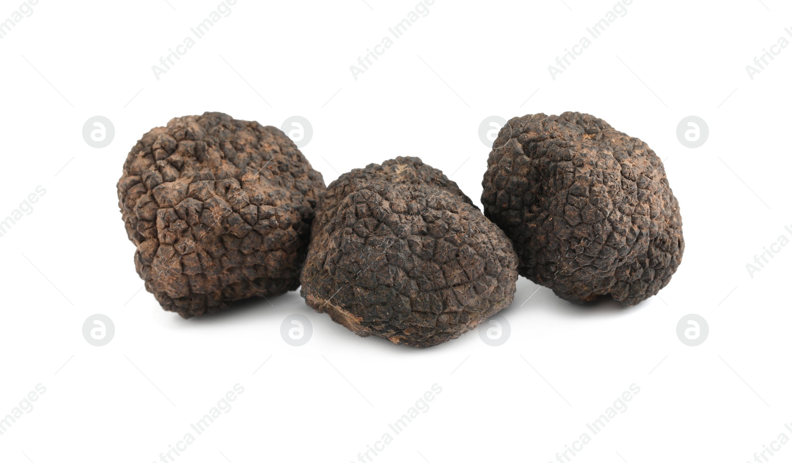 Photo of Fresh whole black truffles isolated on white