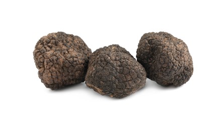 Photo of Fresh whole black truffles isolated on white