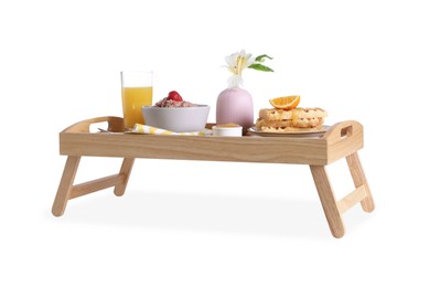 Wooden tray with delicious breakfast and beautiful flower on white background