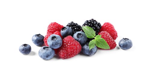 Photo of Many different ripe berries and mint leaves isolated on white