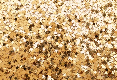 Photo of Confetti stars as background,  top view. Christmas celebration