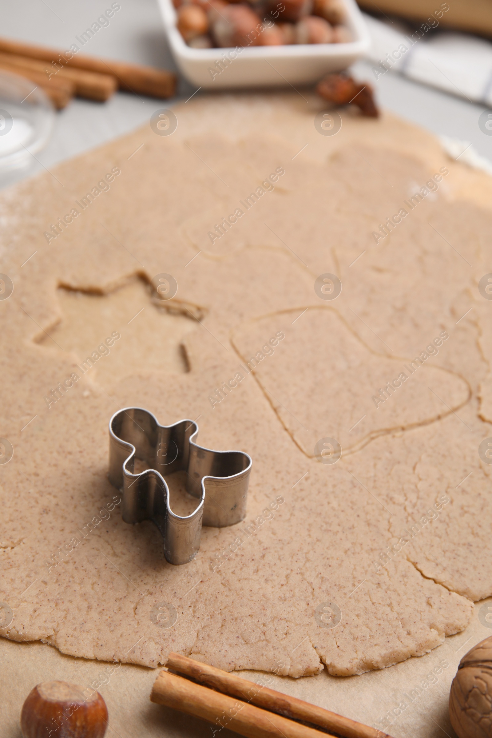 Photo of Homemade Christmas biscuits. Dough and cookie cutter on table, closeup