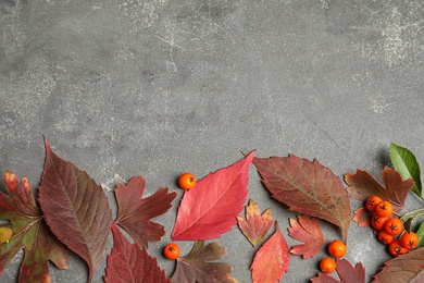 Flat lay composition with autumn leaves on grey stone background. Space for text