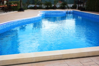 Pool with clean water near buildings outdoors