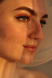 Photo of Fashionable portrait of beautiful woman with fake freckles, closeup