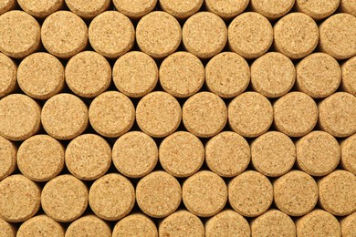 Photo of Many wine bottle corks as background, top view