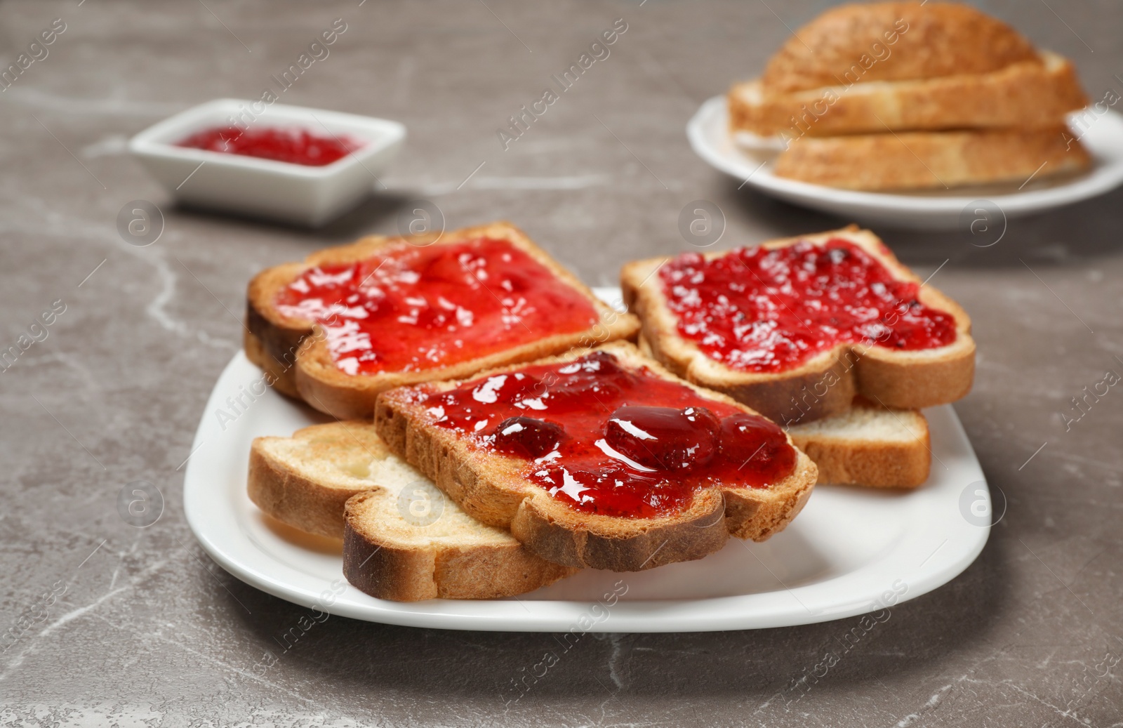 Photo of Tasty toasts with jam on plate, closeup