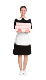 Photo of Young chambermaid holding stack of fresh towels on white background