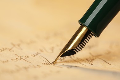 Photo of Writing letter with beautiful fountain pen, closeup