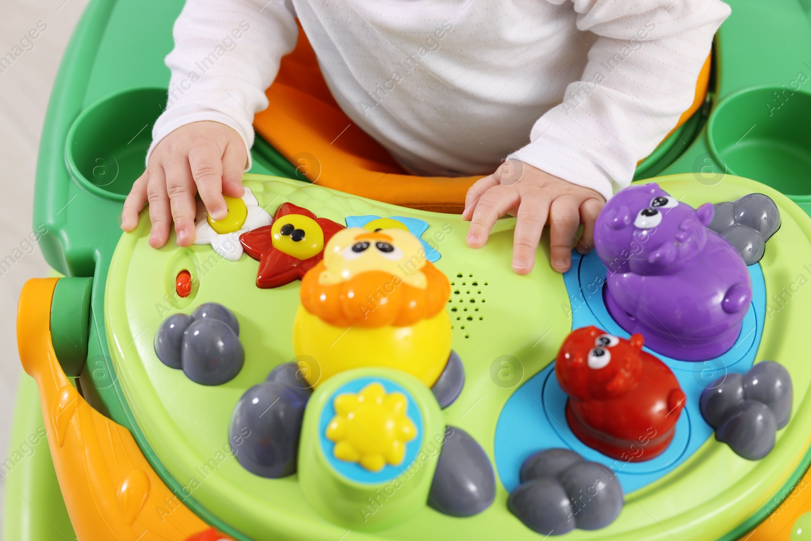 Photo of Little child in baby walker, closeup view